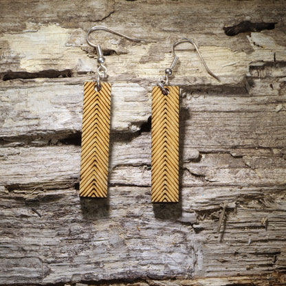 Handcrafted wooden bar dangle earrings featuring an engraved chevron pattern on natural wood. Lightweight geometric earrings with hypoallergenic .925 sterling silver hooks, perfect for minimalist jewelry lovers, boho fashion, modern style, everyday wear, and handmade statement accessories.