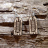 Handcrafted wooden rabies vaccine dangle earrings inspired by a vintage rabies vaccine vial or medical ampoule illustration. These lightweight, laser-cut wooden earrings feature engraved scientific details and are finished with hypoallergenic .925 sterling silver hooks. A unique accessory for veterinarians, medical professionals, microbiologists, laboratory workers, public health advocates, and anyone with an appreciation for unusual science-themed jewelry.
