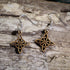 Handmade Celtic knot wooden dangle earrings featuring an intricate endless Celtic knot design. Lightweight Irish-inspired earrings crafted from wood with hypoallergenic .925 sterling silver hooks, perfect for Celtic heritage, Irish culture, pagan traditions, Celtic festivals, and lovers of timeless knotwork jewelry.