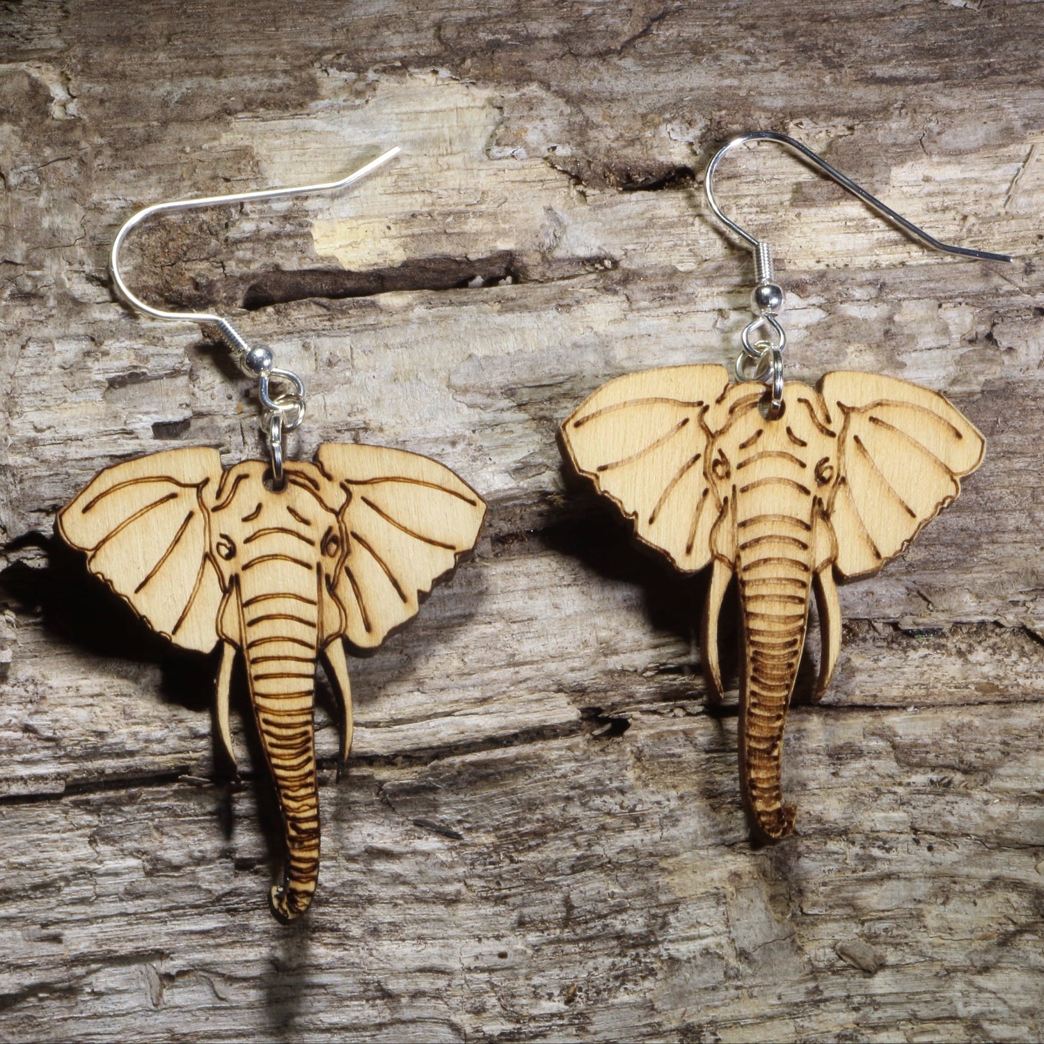 Handmade elephant wooden dangle earrings crafted from lightweight laser-cut wood with hypoallergenic .925 sterling silver hooks. African wildlife jewelry featuring a detailed elephant face, perfect for elephant lovers, safari enthusiasts, zoo supporters, nature lovers, and unique animal gifts.
