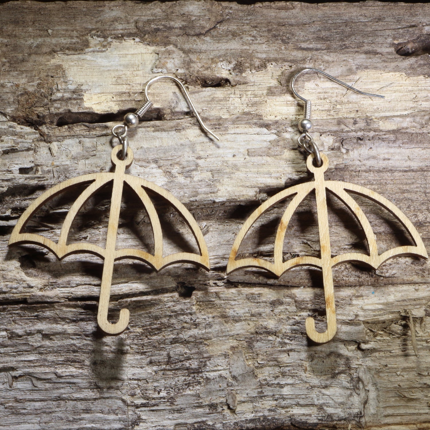 Handmade wooden umbrella dangle earrings featuring an open umbrella silhouette on hypoallergenic .925 sterling silver hooks. Lightweight weather-inspired jewelry for rainy day lovers, spring fashion, umbrella collectors, and unique everyday accessories.