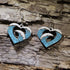 Hand-painted wooden heart wave dangle earrings featuring an ocean wave flowing through an open heart design. Lightweight beach-inspired earrings with hypoallergenic .925 sterling silver hooks, perfect for surfers, ocean lovers, beach enthusiasts, coastal style, sea lovers, and anyone who carries the beach in their heart.