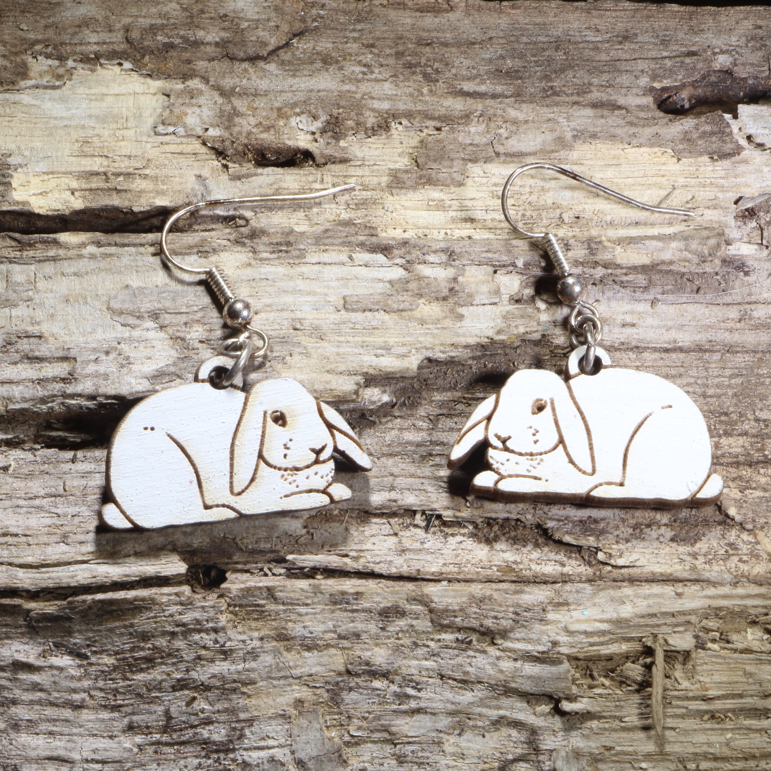 Handcrafted Holland Lop rabbit wooden dangle earrings featuring adorable floppy-eared bunny designs with hand-painted details. Lightweight laser-cut wooden earrings with hypoallergenic .925 sterling silver hooks, perfect for Holland Lop owners, rabbit lovers, bunny enthusiasts, pet parents, and unique handmade animal jewelry.