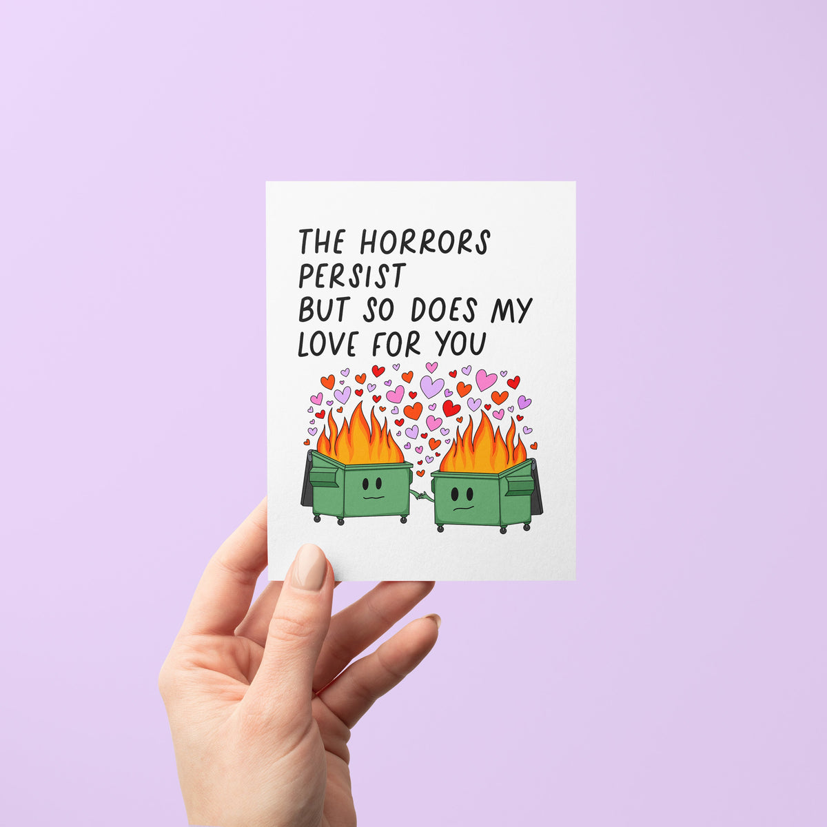 Horrors Persist love card flat lay — funny illustrated dumpster fire love card by indie artist MangoIllustrated