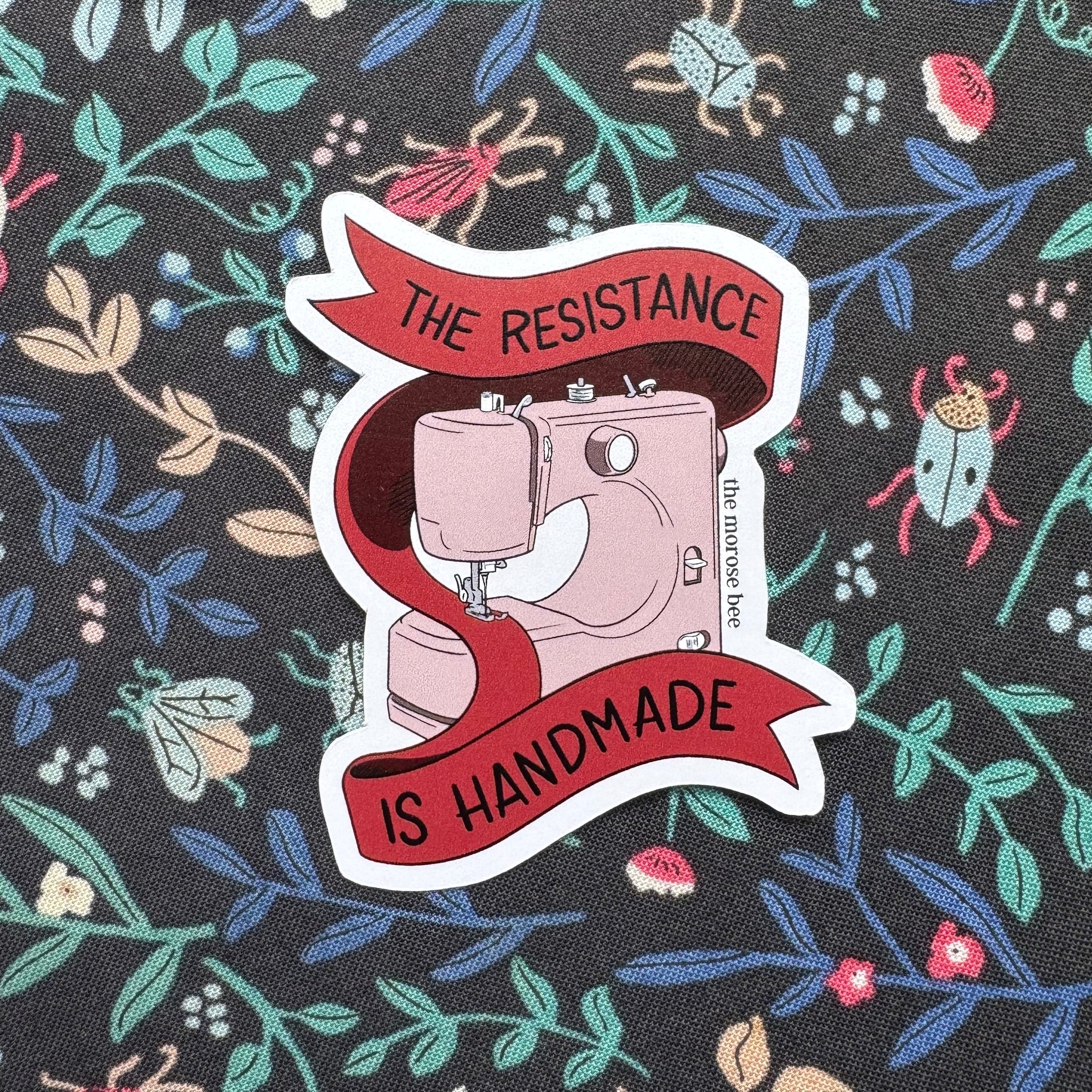 Sticker with sewing machine graphic and &