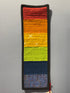 Colorful woven strip with a pattern on a gray surface
