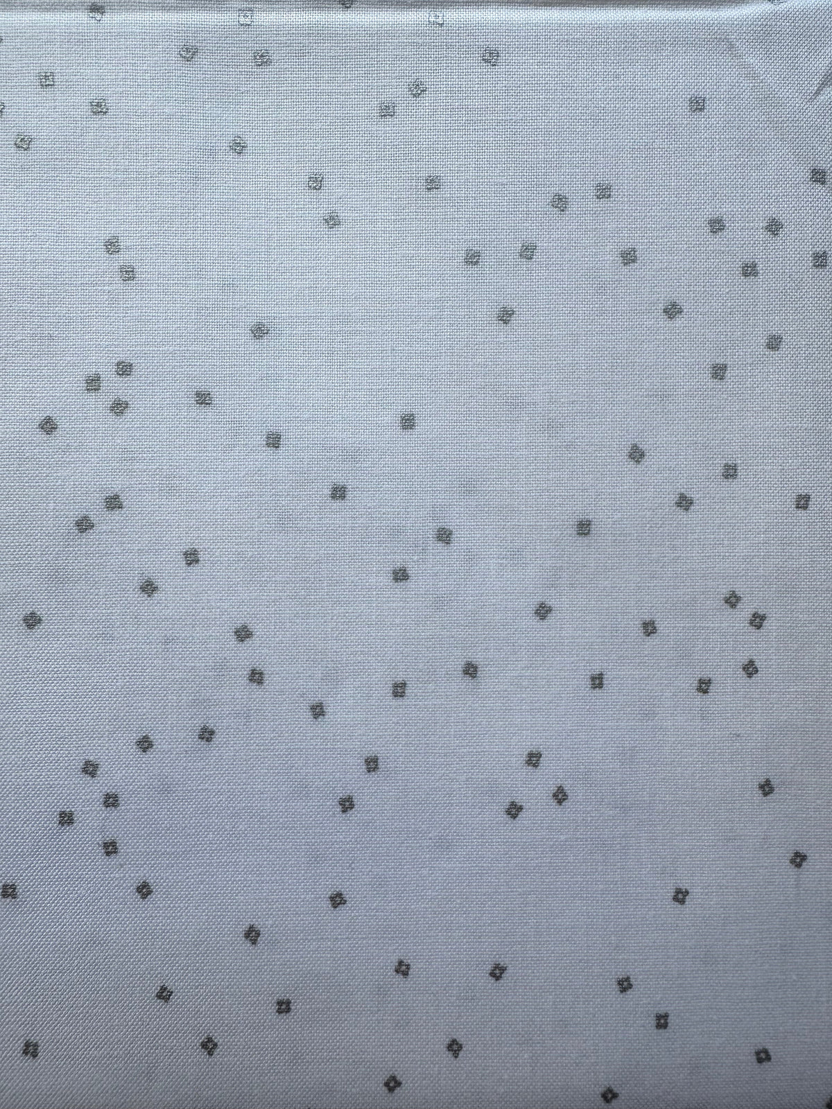 White fabric with small silver diamond patterns