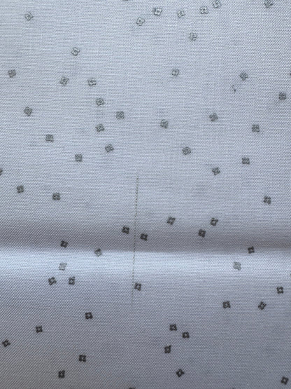 White fabric with small silver diamond patterns