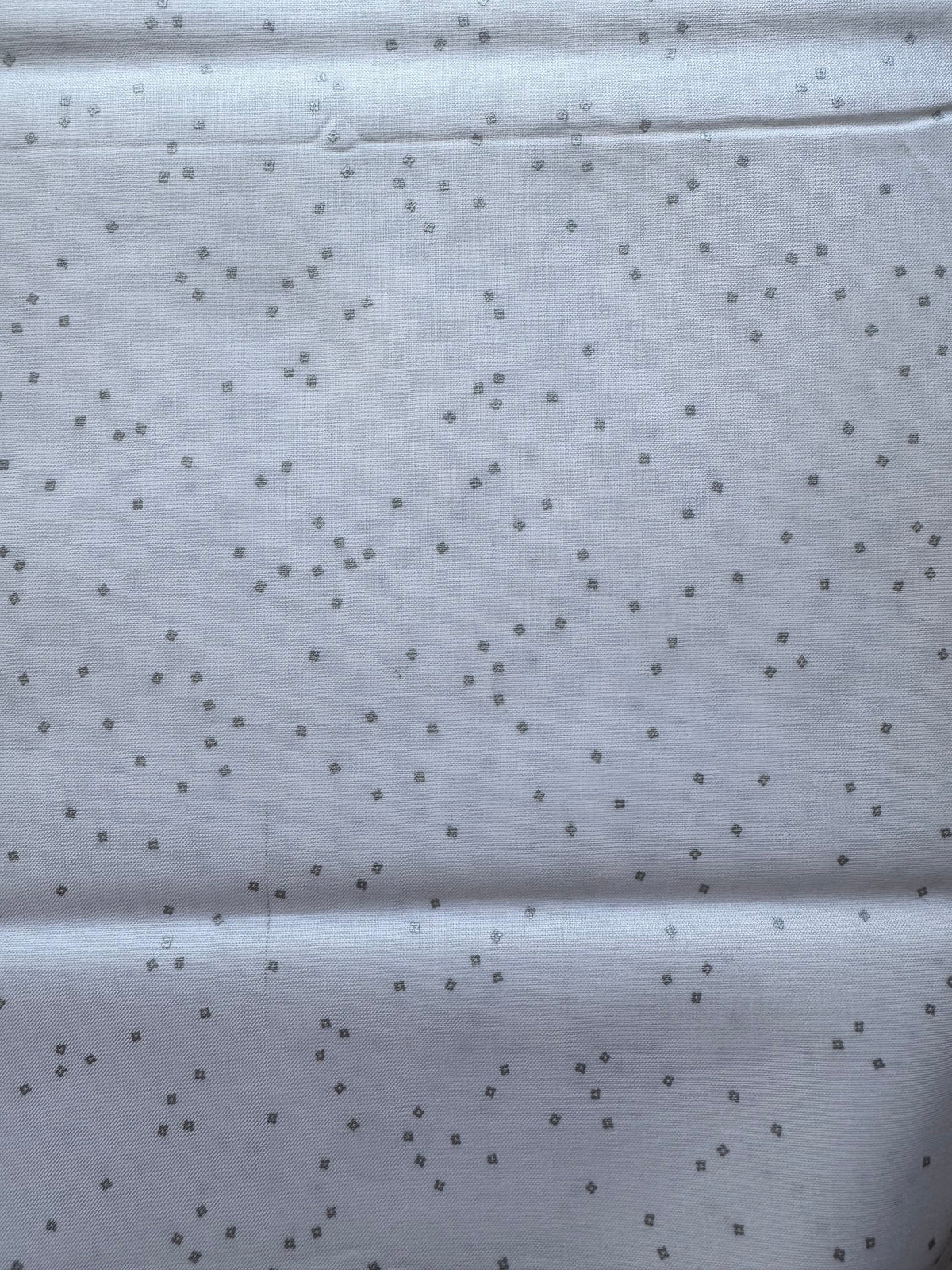White fabric with small silver diamond patterns