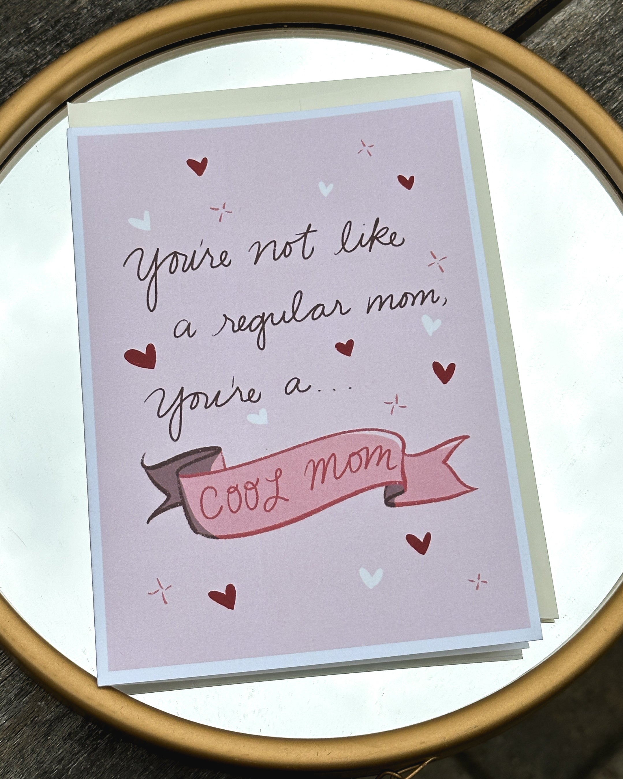 A 5x7 inch greeting card with a pink background featuring the text &