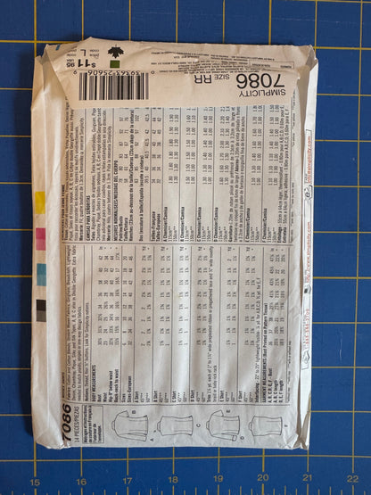 A flat lay of a Sew-It! brand sewing pattern envelope, pattern number 1086, showing the back with size charts and garment illustrations, placed on a blue cutting mat.