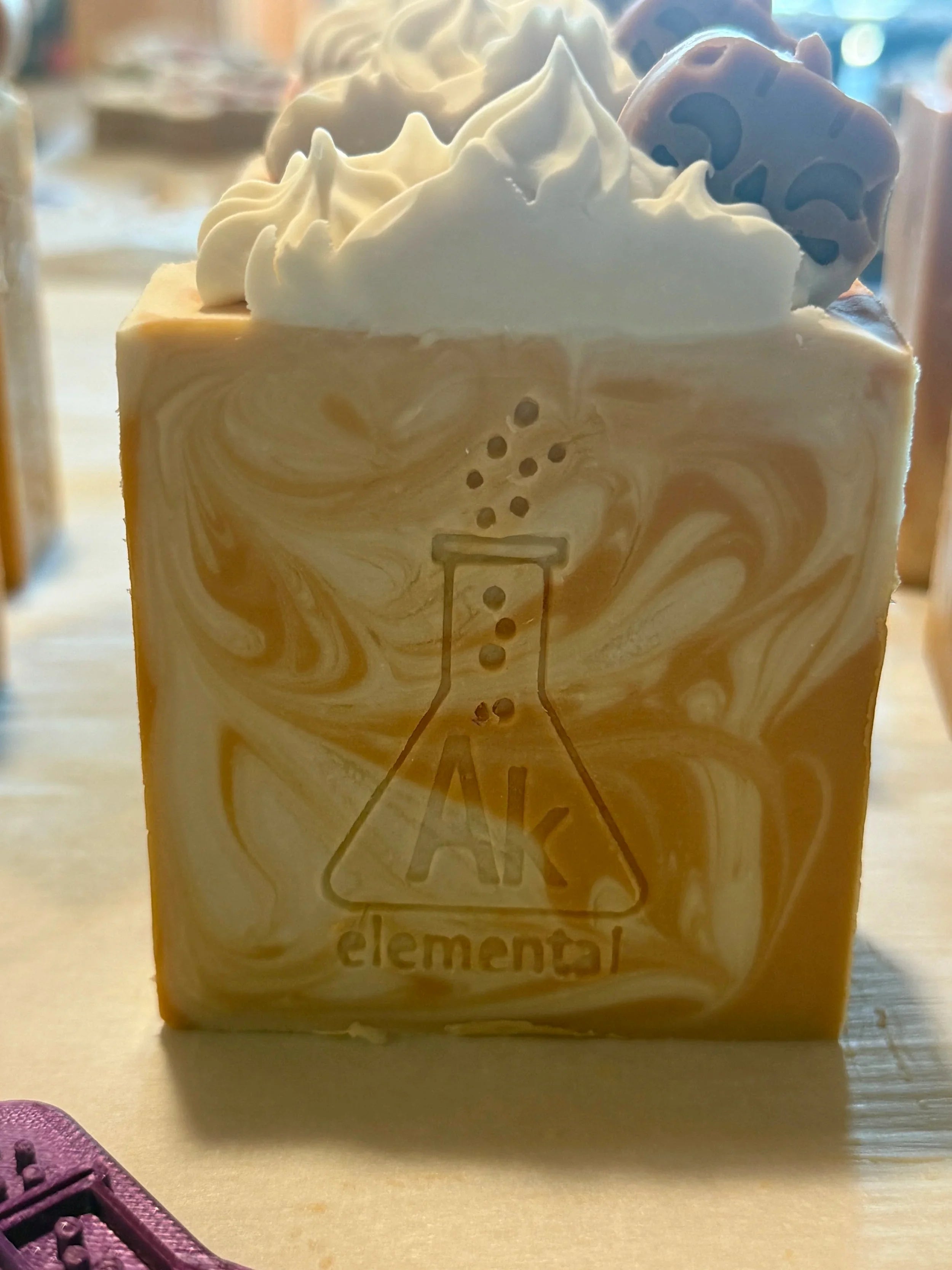 Square soap bar with swirls of cream, orange, and warm brown