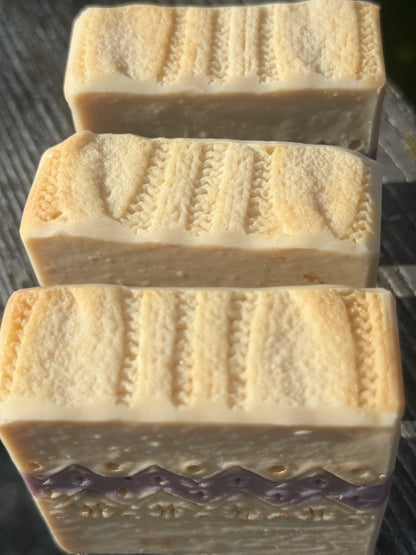 Top of three handcrafted Ugly Sweater holiday soap bars with pattern that looks like a cable knit sweater.