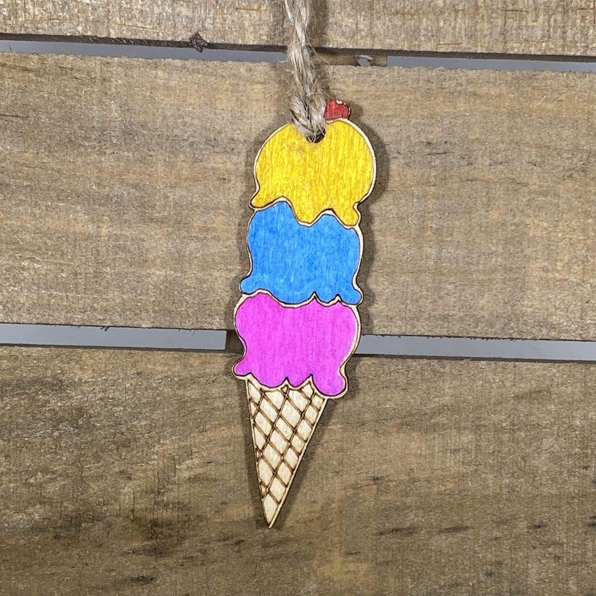 Hand-painted wooden ice cream cone Christmas ornament featuring a colorful scoop atop a classic cone with playful dessert details, festive holiday decor for sweet treat lovers and fun-loving homes by Cate’s Concepts