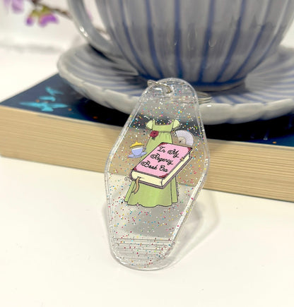 Inspired by the romance of the Regency Era, this whimsical hand drawn empire dress is paired with trinkets of the time including a cute teacup, tiara and fan! 📖 ☕ ✨👑 Perfect motel keychain for any bookish babe. Pair it with the matching sticker!