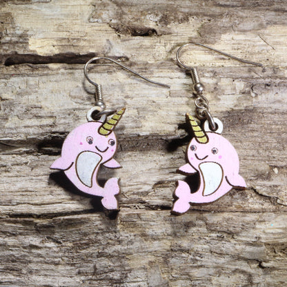 Handcrafted kawaii narwhal wooden dangle earrings featuring adorable smiling narwhals with colorful hand-painted details and signature tusks. Lightweight laser-cut wooden earrings with hypoallergenic .925 sterling silver hooks, perfect for ocean animal lovers, narwhal fans, kawaii fashion enthusiasts, marine life collectors, and cute handmade jewelry.