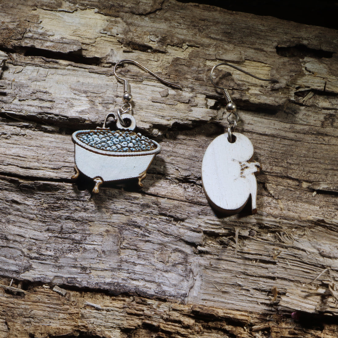 Hand-painted wooden kidney soaking in a bathtub dangle earrings on hypoallergenic .925 sterling silver hooks. Lightweight nephrology-inspired medical jewelry for nephrologists, nephrology nurses, dialysis staff, and kidney health advocates.