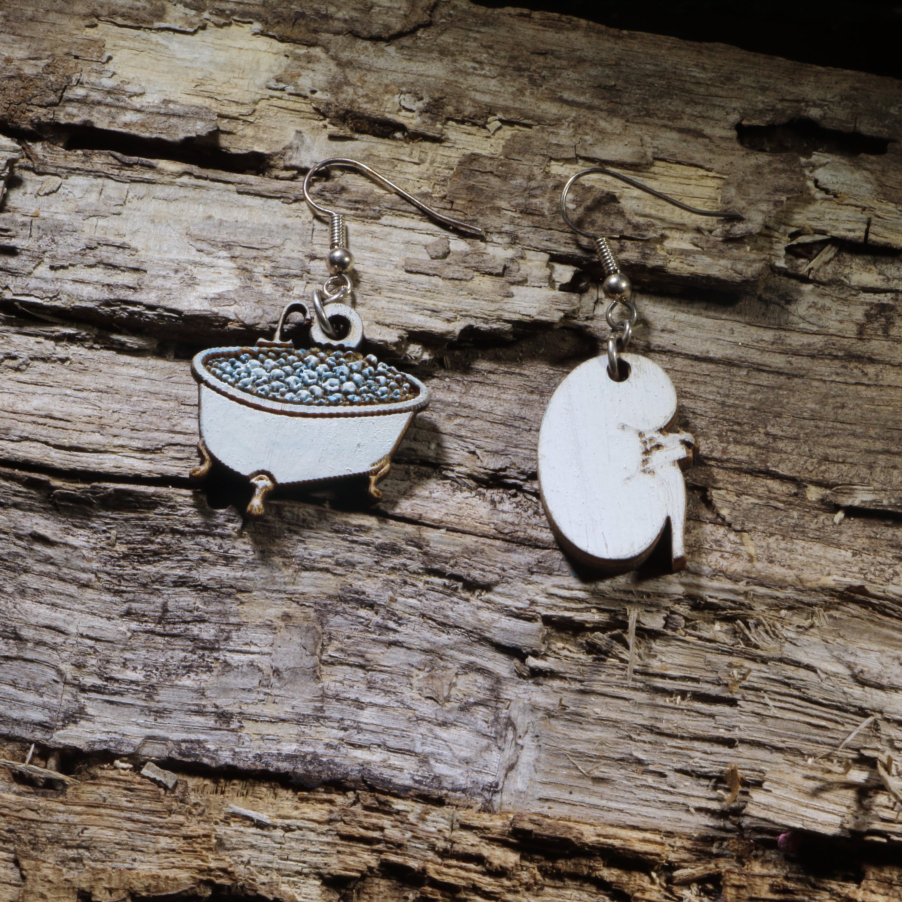 Hand-painted wooden kidney soaking in a bathtub dangle earrings on hypoallergenic .925 sterling silver hooks. Lightweight nephrology-inspired medical jewelry for nephrologists, nephrology nurses, dialysis staff, and kidney health advocates.