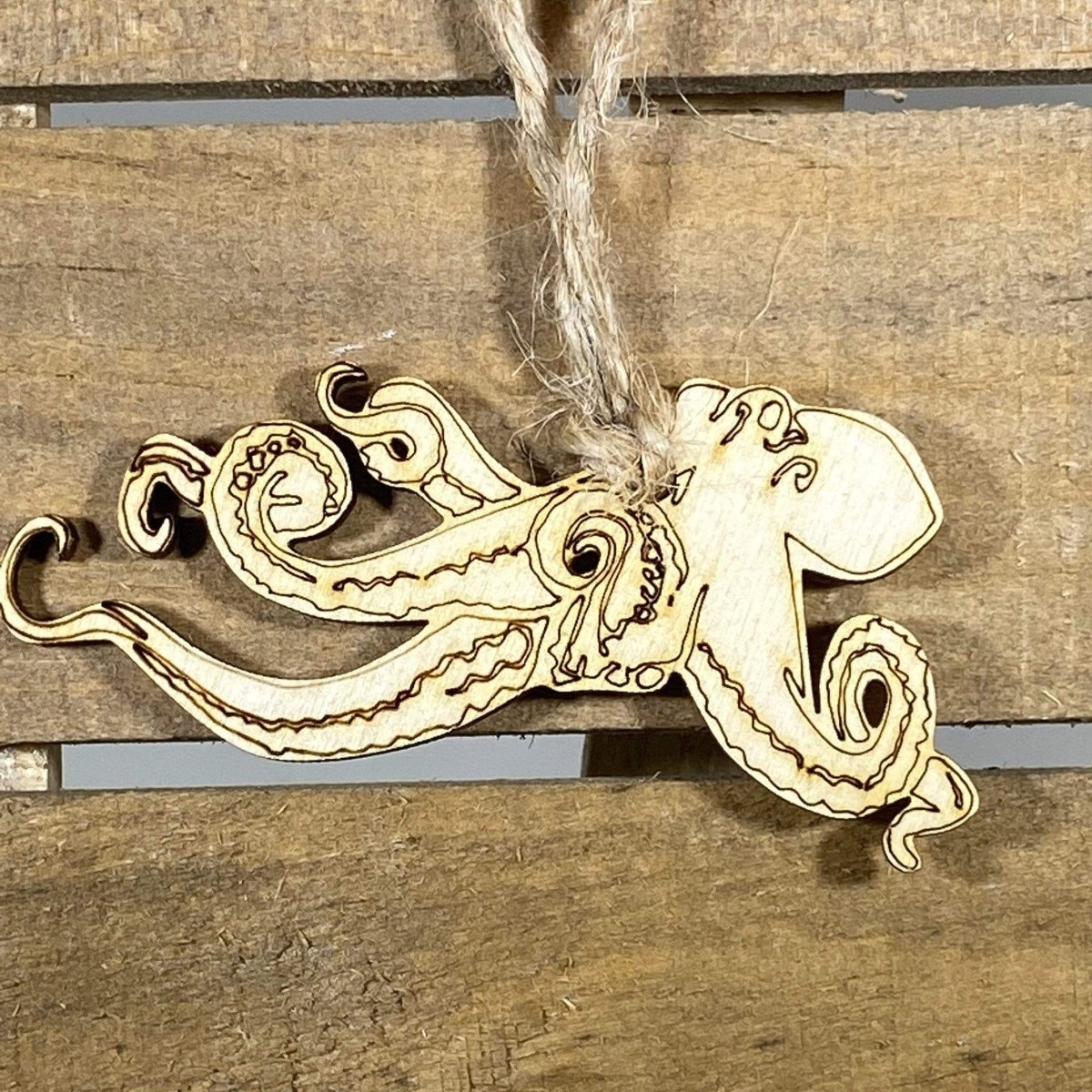 Hand-painted wooden kraken Christmas ornament featuring a detailed mythical sea creature with swirling tentacles in nautical style, unique holiday decor for ocean lovers and mythology fans by Cate’s Concepts