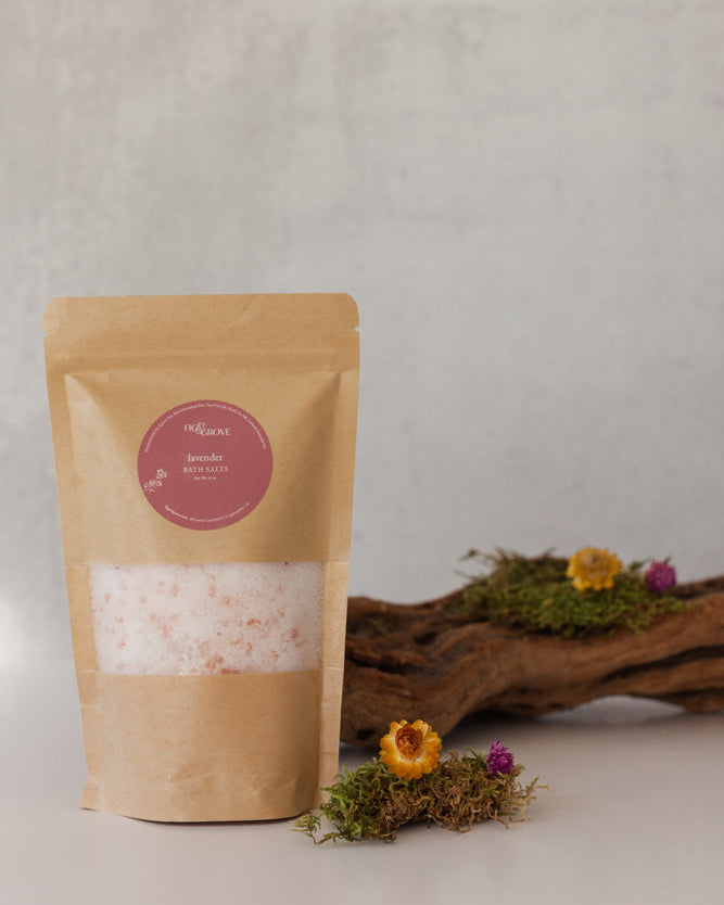 Lavender bath salts in a Kraft resealable pouch with a pink label on a neutral background with decorative elements - Fig &amp; Grove