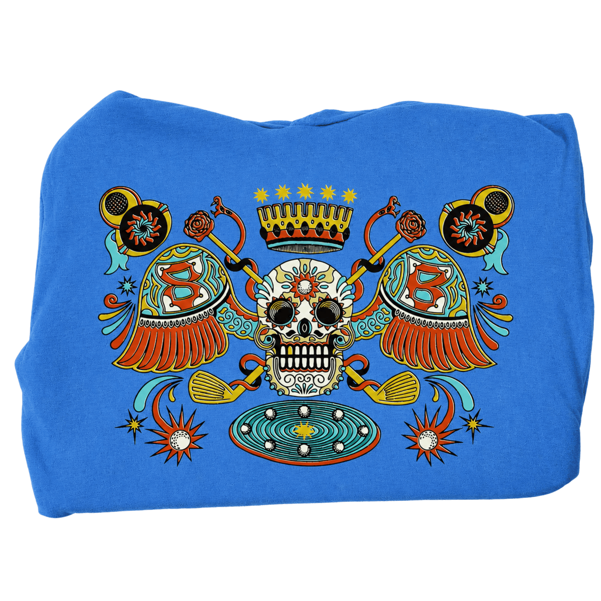 A folded blue sweatshirt or hoodie featuring a large, colorful Day of the Dead (Dia de los Muertos) style graphic print on the front. The graphic includes a central sugar skull, a crown, two crossed rifles, ornate shields with the letter &
