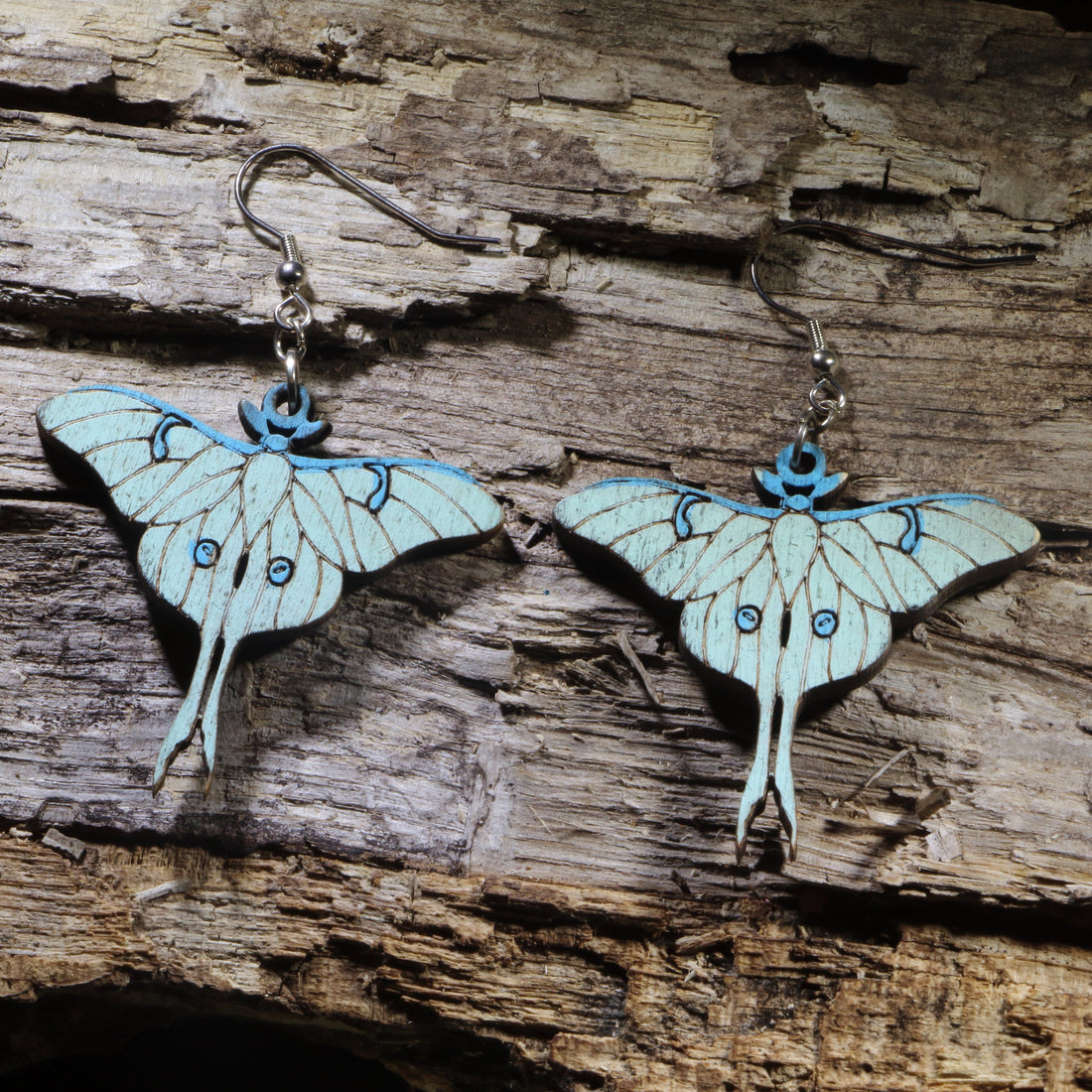 Hand-painted Luna moth wooden dangle earrings on hypoallergenic .925 sterling silver hooks. Lightweight moth nature jewelry for insect lovers, entomologists, gardeners, and woodland nature enthusiasts.