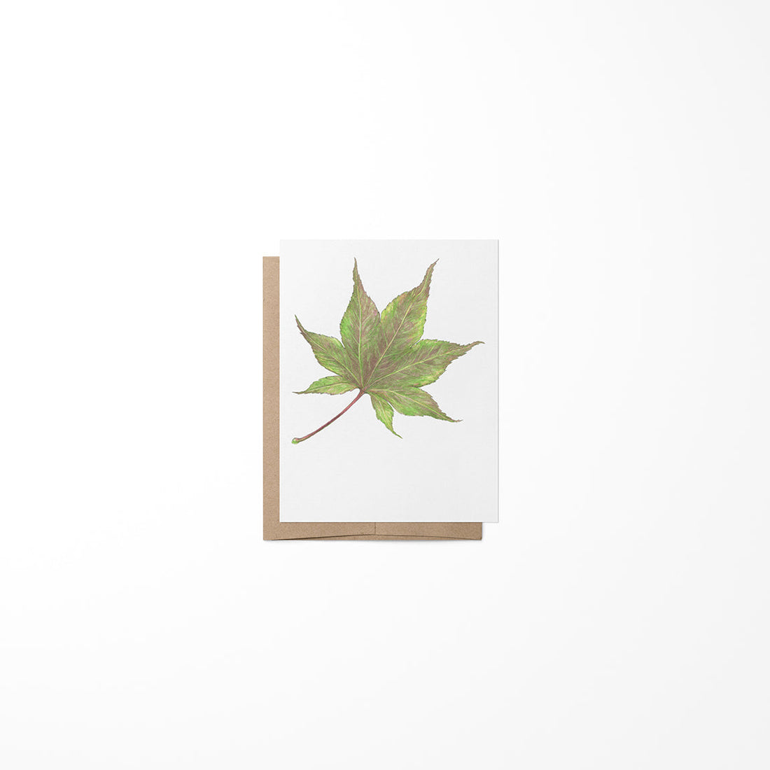 A greeting card featuring a maple leaf design by Heather S Vitticore, presented on a white background.