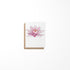 A greeting card featuring a color illustration of a lily flower on the front, with a blank inside for a message, presented against a white background.