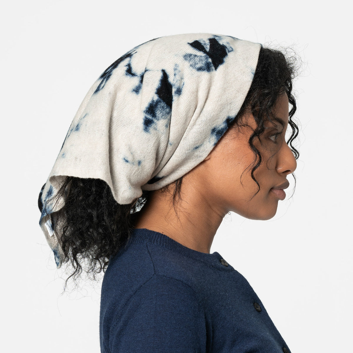 Fair trade blue and white merino wool scarf shown as headscarf on a model