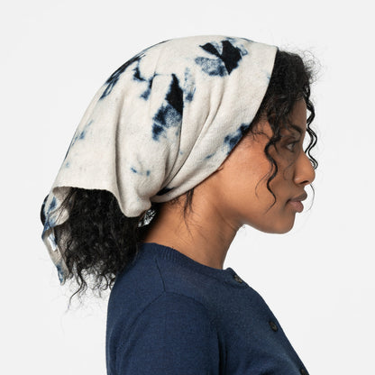 Fair trade blue and white merino wool scarf shown as headscarf on a model