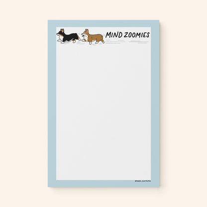Mind Zoomies corgi notepad flat lay — funny corgi notepad for racing thoughts by indie artist MangoIllustrated