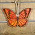 Hand-painted wooden monarch butterfly Christmas ornament featuring detailed orange and black wing patterns with nature-inspired design, unique holiday decor for butterfly lovers and garden enthusiasts by Cate’s Concepts