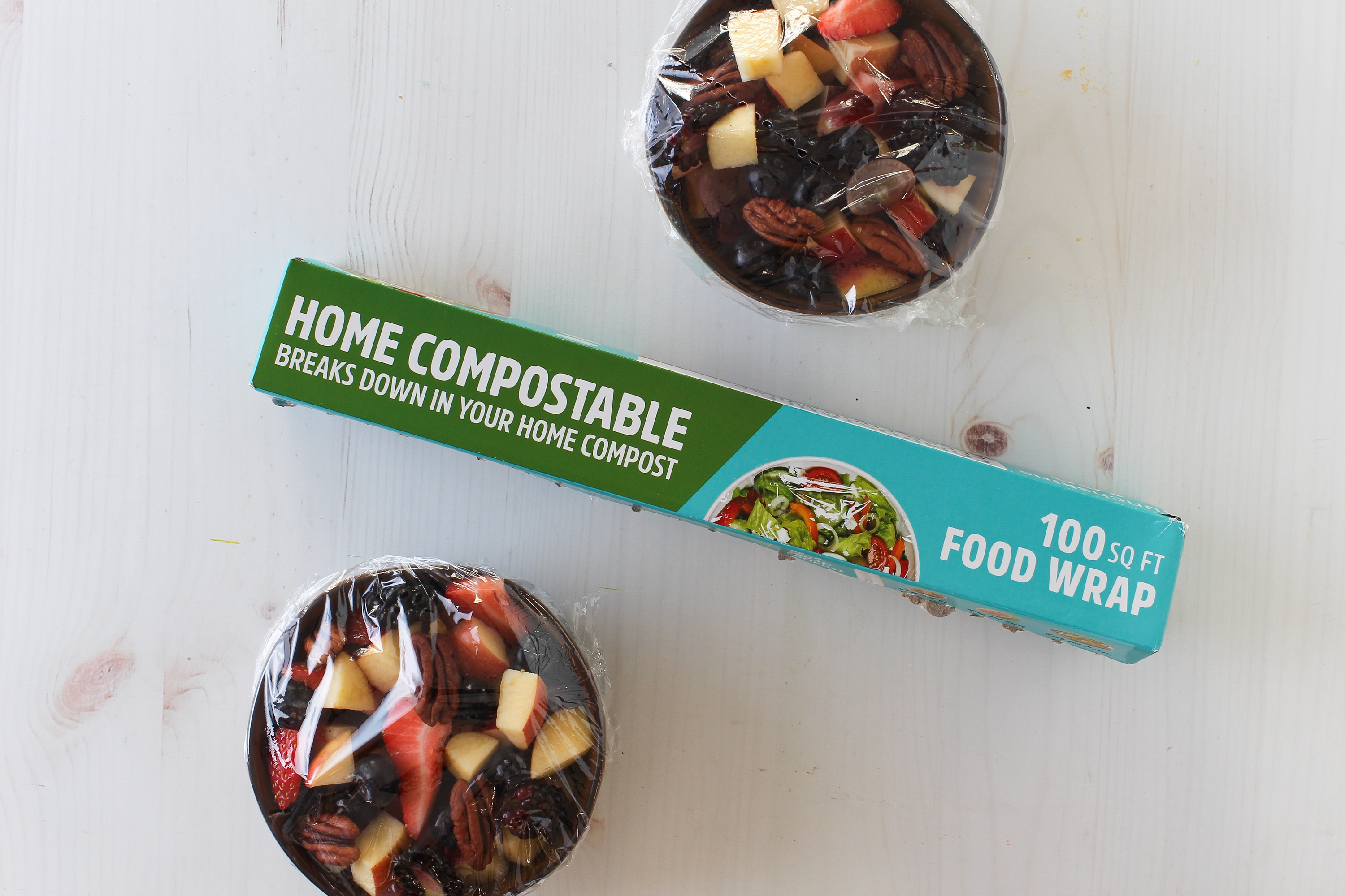 Home compostable food wrap with two wrapped food items on a white surface