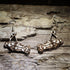 Natural wood theatrical spotlight dangle earrings featuring detailed stage lighting instruments with mounting yokes. Lightweight theater jewelry perfect for theatre teachers, technicians, lighting designers, stage crews, drama students, and performing arts gifts.