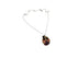 Ethically made, silver chain necklace with a ladybug pendant featuring purple and pink silk hand sewn on leather with ethically sourced bead stones and recycled materials, flay lay