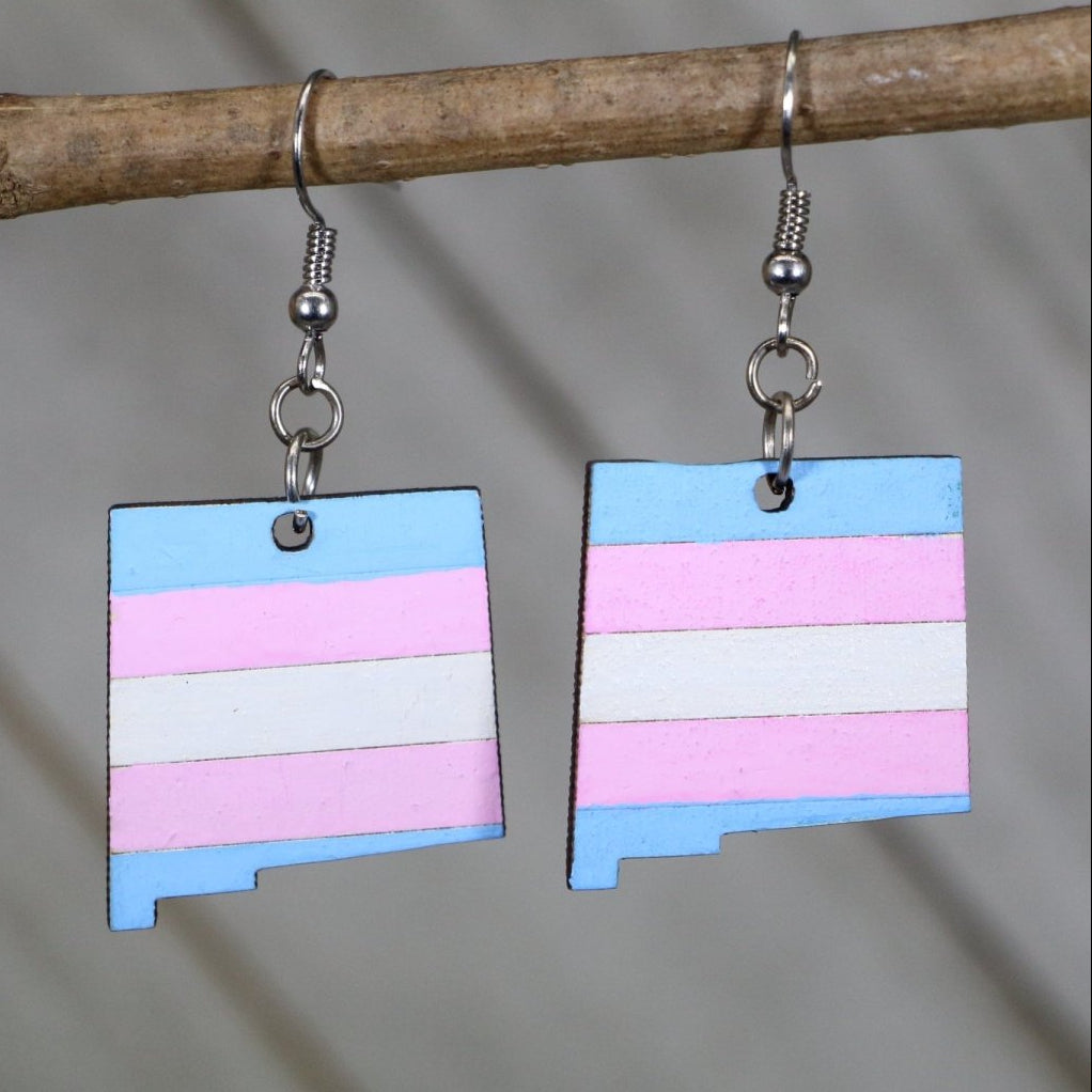 Hand-painted wooden New Mexico trans pride dangle earrings with Zia sun symbol and transgender flag colors design and hypoallergenic sterling silver hooks, lightweight pride statement jewelry earrings for NM state pride and LGBTQ expression 