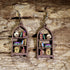 Handcrafted Oddities Bookshelf wooden dangle earrings featuring a detailed bookshelf filled with skulls, potion bottles, vintage books, mushrooms, curiosities, and mystical treasures. Lightweight laser-cut wooden earrings with hypoallergenic .925 sterling silver hooks, perfect for gothic jewelry lovers, dark academia enthusiasts, librarians, bookworms, Halloween fans, and collectors of oddities.