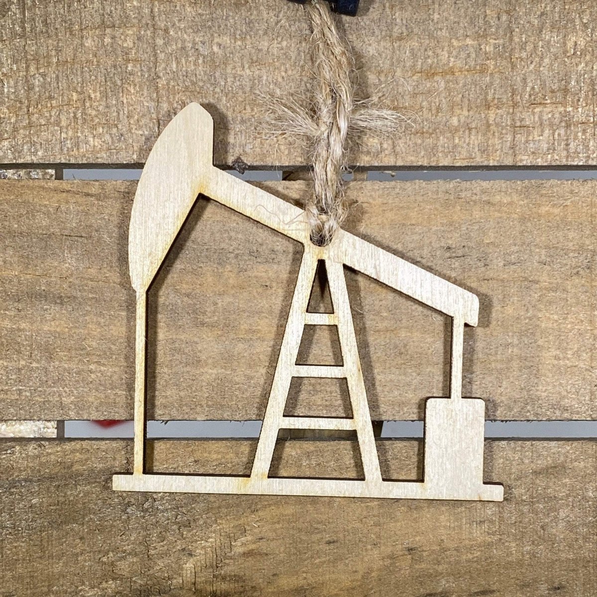 Hand-painted wooden oil pump jack Christmas ornament featuring a detailed Texas oilfield silhouette with moving arm design and industrial accents, unique holiday decor for oil workers and Texas pride enthusiasts by Cate’s Concepts