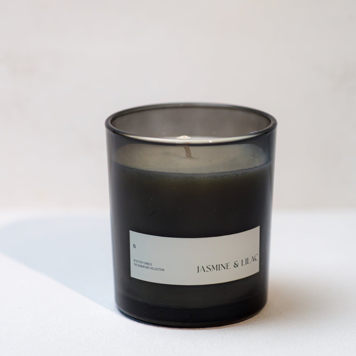 Black candle with a label on a white background