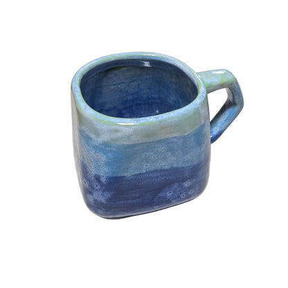 Blue ceramic mug on a light-colored surface