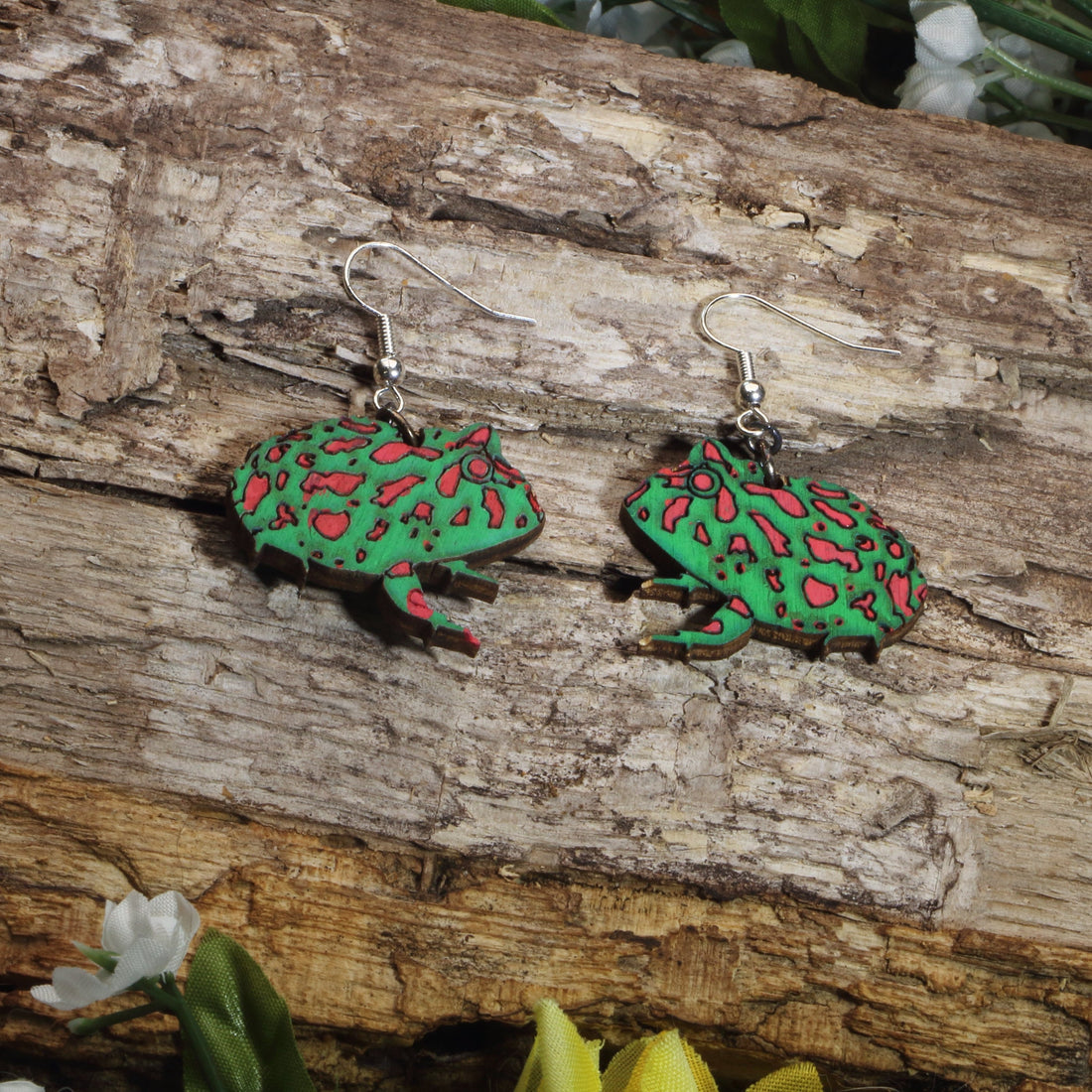 Hand-painted wooden Pacman frog dangle earrings featuring a vibrant green and red exotic amphibian design, hypoallergenic sterling silver hooks, and lightweight animal jewelry for frog lovers, reptile enthusiasts, and nature-inspired style by Cate’s Concepts.