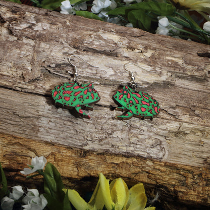 Hand-painted wooden Pacman frog dangle earrings featuring a vibrant green and red exotic amphibian design, hypoallergenic sterling silver hooks, and lightweight animal jewelry for frog lovers, reptile enthusiasts, and nature-inspired style by Cate’s Concepts.
