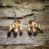 Pair of natural wood gorilla dangle earrings featuring detailed engraved gorilla designs displayed on rustic weathered wood