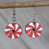 Hand-painted wooden peppermint candy dangle earrings with festive Christmas swirl design and hypoallergenic sterling silver hooks, lightweight candy statement jewelry earrings for holiday and winter style