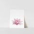 A vertical art print of a pink lily flower with a white background, placed on a shelf.