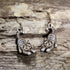 Handcrafted playful gray tabby cat wooden dangle earrings featuring an adorable gray tabby with bright green eyes and a playful pose. Lightweight laser-cut wooden earrings with hypoallergenic .925 sterling silver hooks, perfect for cat lovers, tabby cat owners, pet parents, feline enthusiasts, and unique handmade animal jewelry.