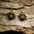 Hand-painted wooden pot of gold dangle earrings featuring a treasure-filled pot overflowing with bright gold coins inspired by Irish folklore. Crafted from lightweight wood with hypoallergenic .925 sterling silver hooks, these festive earrings are perfect for St. Patrick&