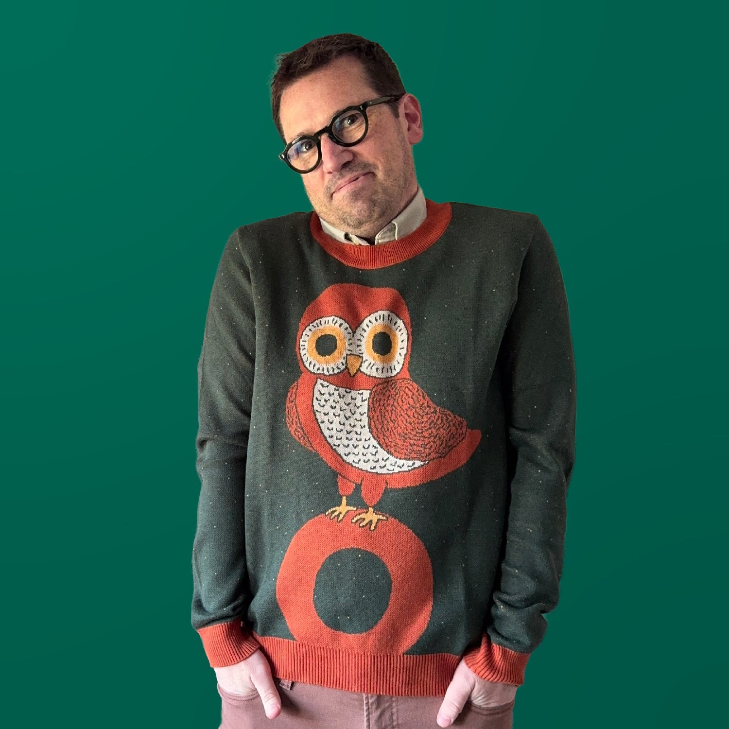 Artist Jedd wearing the Owl on a Vowel graphic knit sweater — designer knitwear made to order