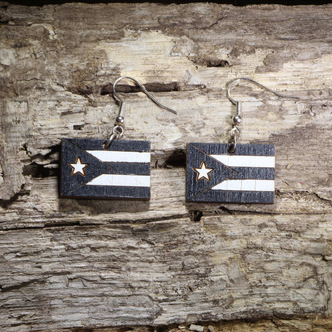 Handcrafted Puerto Rican Black Flag wooden dangle earrings featuring the iconic black-and-white Puerto Rico flag design. Lightweight laser-cut wooden earrings with hypoallergenic .925 sterling silver hooks, perfect for Puerto Rican pride, Boricua heritage, cultural celebrations, patriotic accessories, and everyday wear.