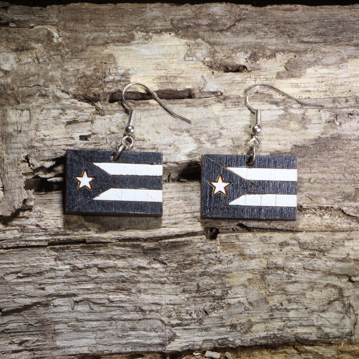 Handcrafted Puerto Rican Black Flag wooden dangle earrings featuring the iconic black-and-white Puerto Rico flag design. Lightweight laser-cut wooden earrings with hypoallergenic .925 sterling silver hooks, perfect for Puerto Rican pride, Boricua heritage, cultural celebrations, patriotic accessories, and everyday wear.